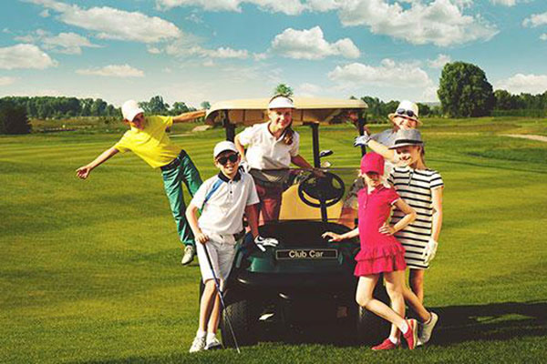 Junior golfers with a buggy